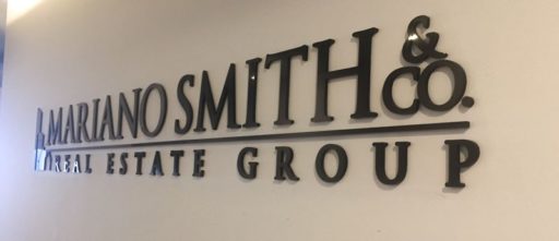 painted matte black acrylic letters mounted flush on interior lobby wall angle