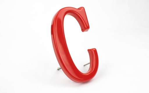 close up of formed plastic letters red caslon adbold font