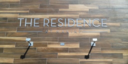 polished stainless steel mounted flush on wood wall apartment complex