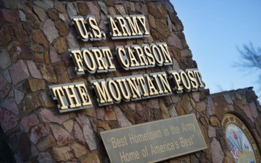 brushed bronze letters mounted on black backer outside fort carson army base