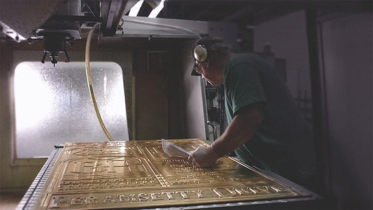 Close-up of a cast bronze plaque during finishing