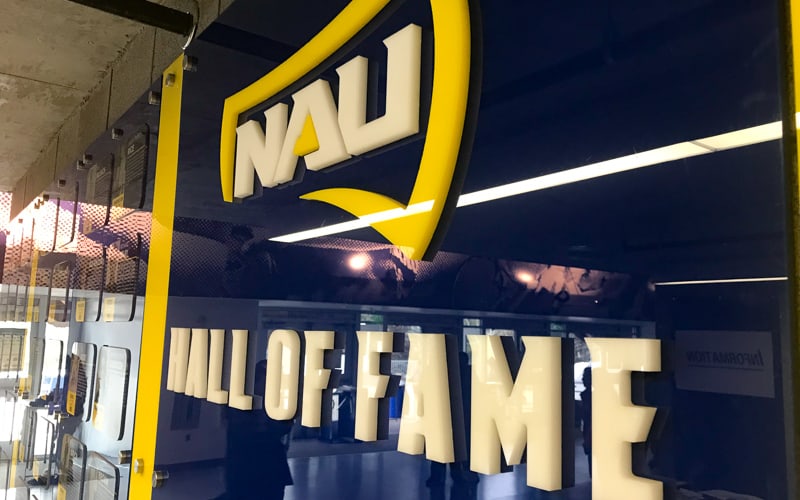 custom acrylic letters and logo in white and yellow glossy on blue acrylic panel for university athletics hall of fame