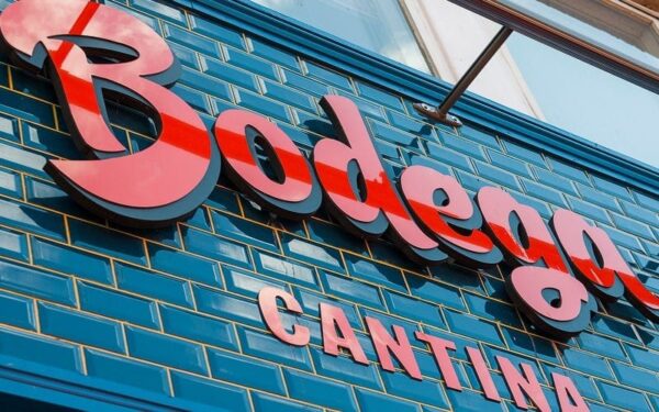 Layered red and black acrylic dimensional sign on a restaurant interior wall