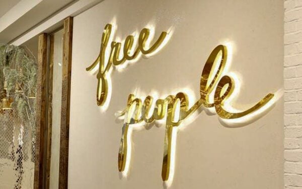 Polished brass backlit metal letters with 5000K LEDs — Free People retail storefront
