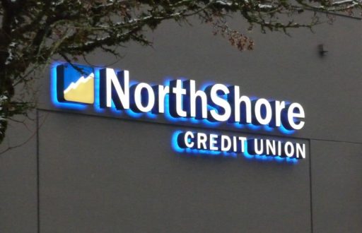 Dual-lit backlit channel letters, face plus halo glow — credit union bank exterior