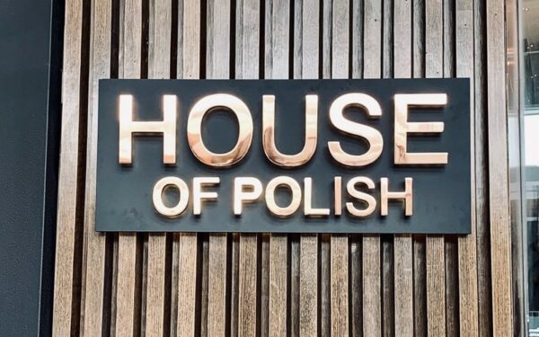 Polished copper fabricated metal letters on an exterior wall