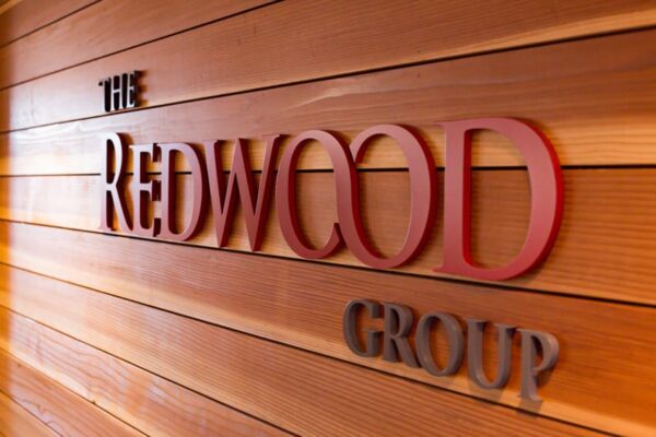 Matte painted acrylic dimensional letters on a lobby wall — Redwood