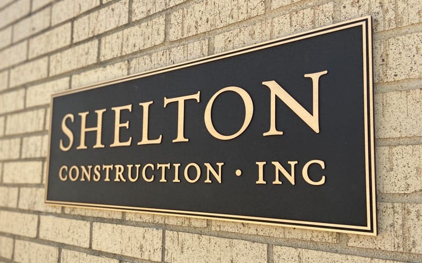 Cast bronze plaque with a brushed finish mounted at a building entrance