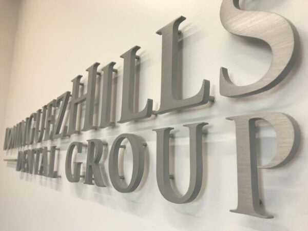 Brushed aluminum lobby sign letters — Hills Dental Group reception