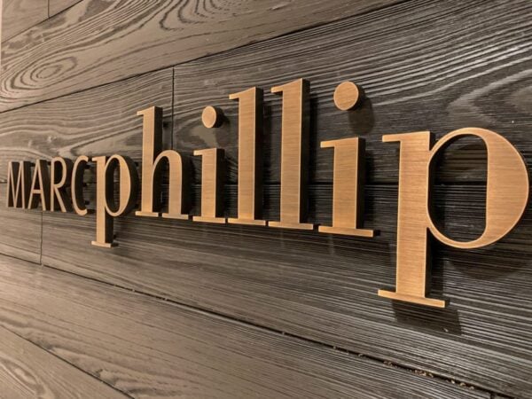 Oxidized solid bronze interior sign letters — Marc Phillip lobby