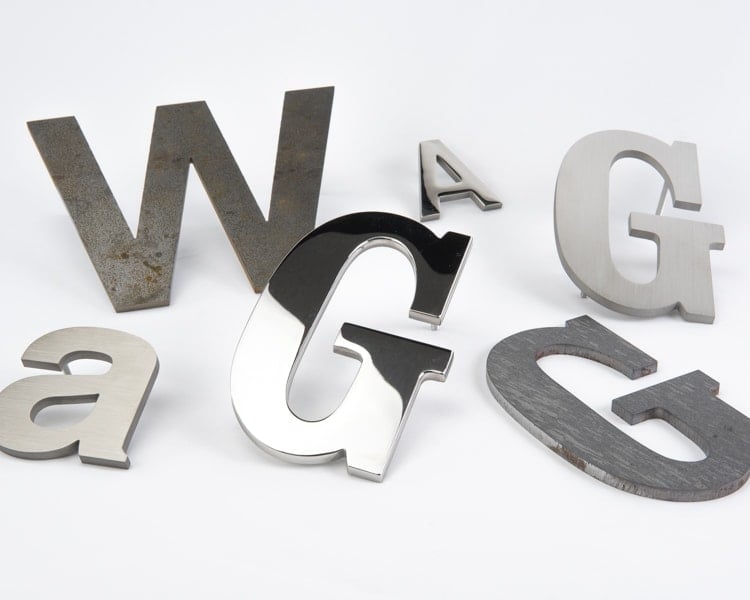 Grouping of solid stainless steel sign letters