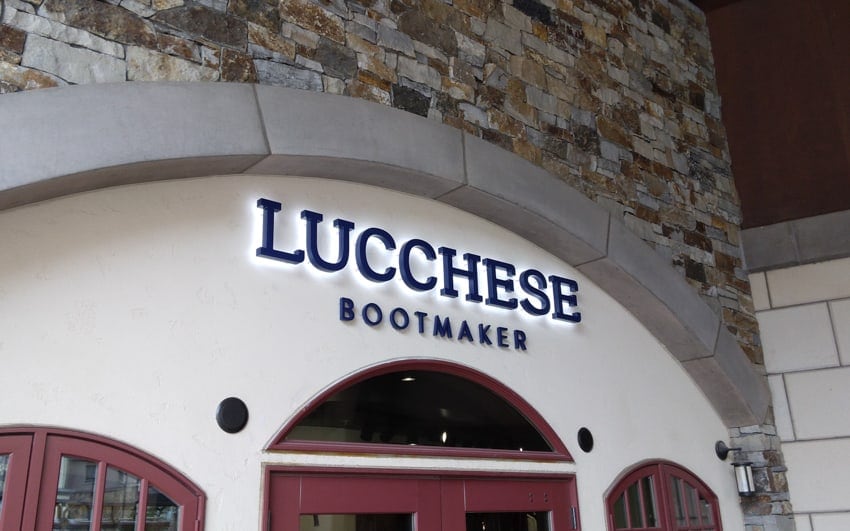 Black painted backlit letters on a retail storefront — Lucchese