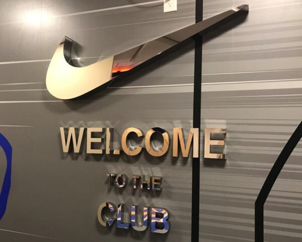 Polished fabricated stainless steel storefront logo — Nike