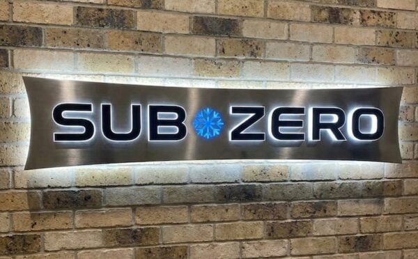 Brushed stainless push-through backlit cabinet sign with 5000K LEDs — Sub-Zero