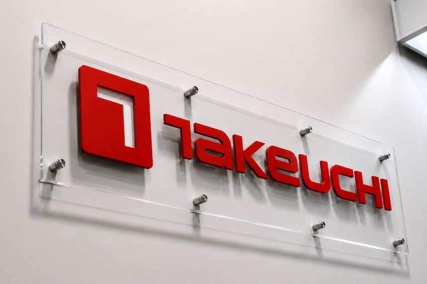Finished red acrylic clear-panel Takeuchi sign installed at one location