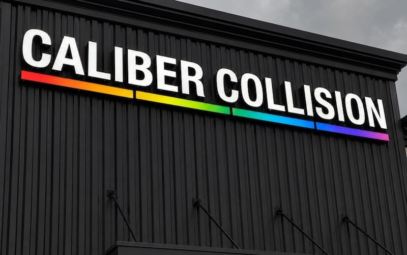 Large-format front lit channel letters on Caliber Collision's industrial building