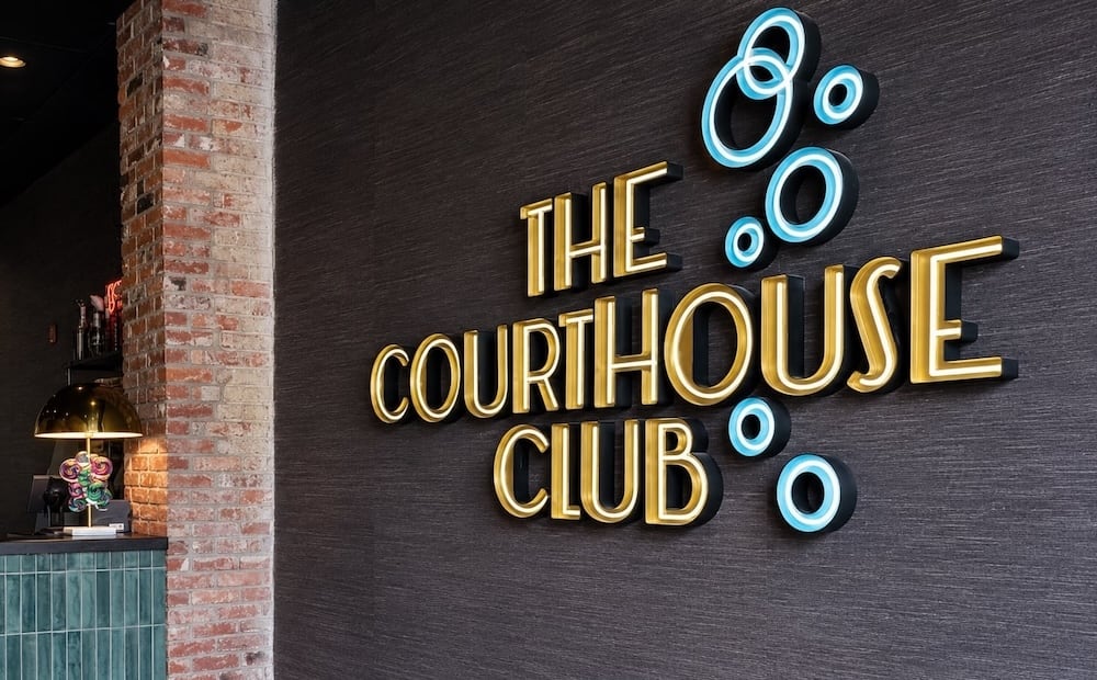 Custom lighted sign with gold dimensional letters and blue open face neon channel letters — Courthouse Club